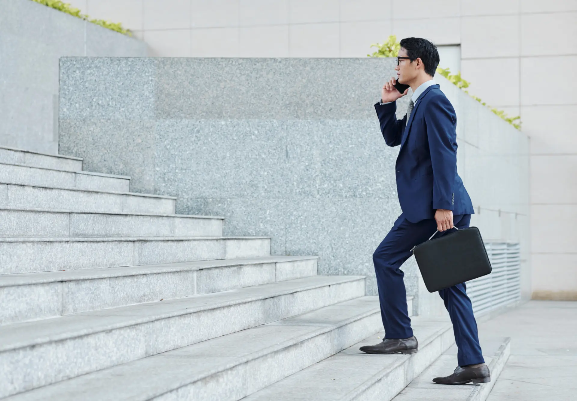 Attorney climbing stairs while on a phone call